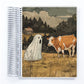 a notebook with a picture of a cow and a ghost