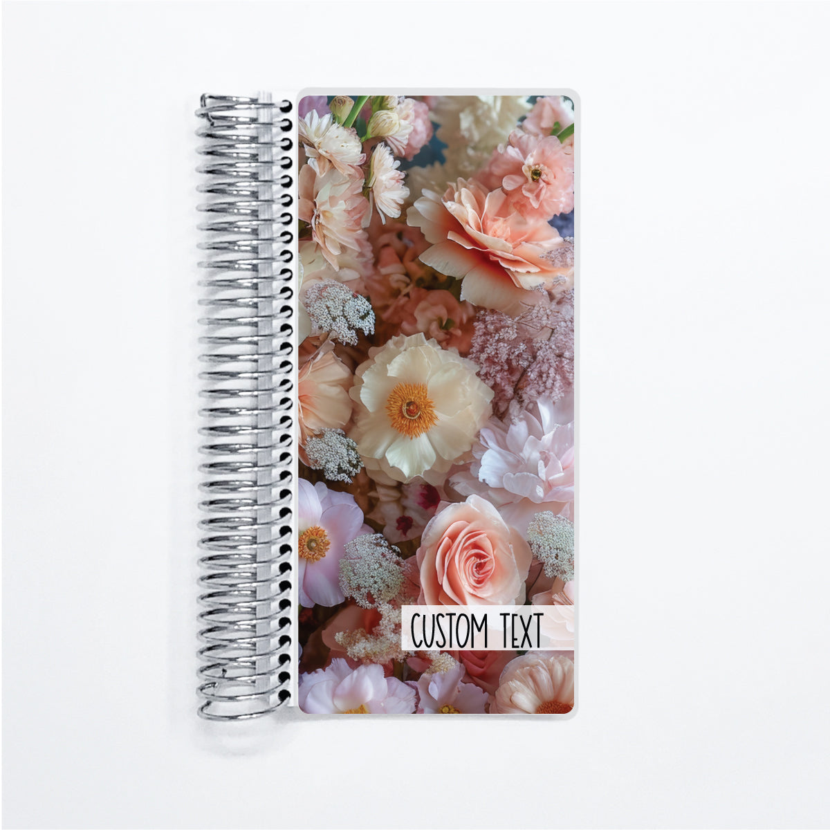 a spiral notebook with a photo of flowers on it