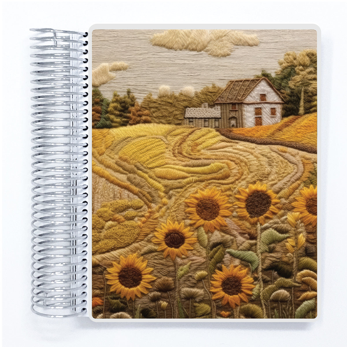 a spiral notebook with a picture of a farm house and sunflowers