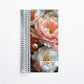a spiral notebook with a photo of pink flowers