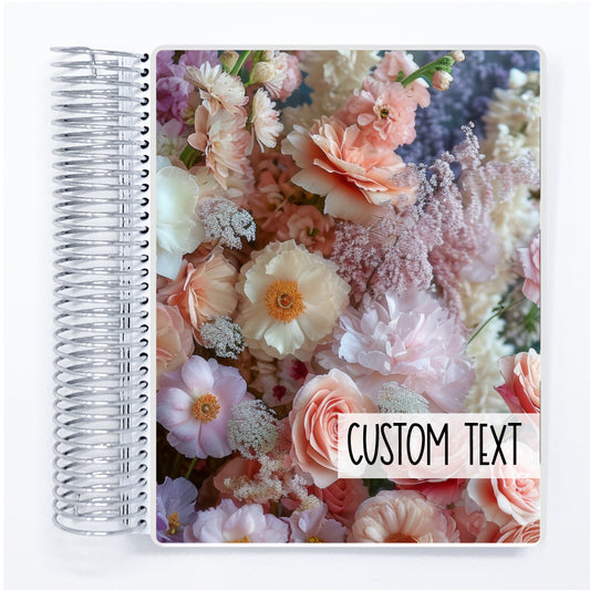 a spiral notebook with a photo of pink and white flowers