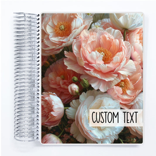 a spiral notebook with a photo of pink flowers