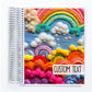 a spiral notebook with a picture of a rainbow and clouds