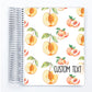 a spiral notebook with a pattern of peaches