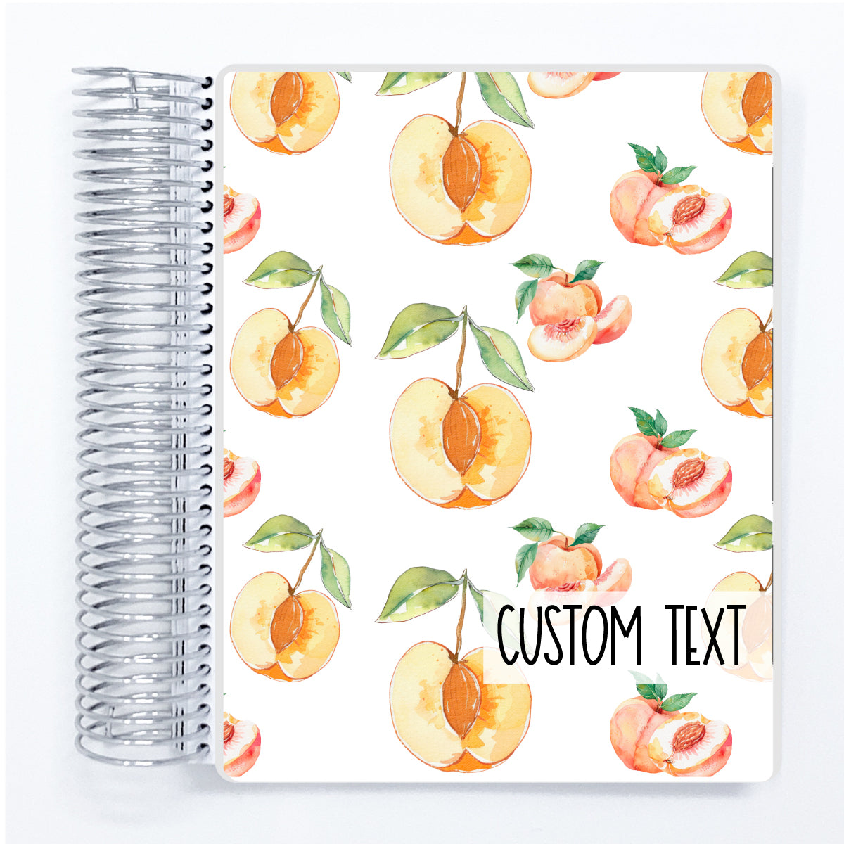 a spiral notebook with a pattern of peaches