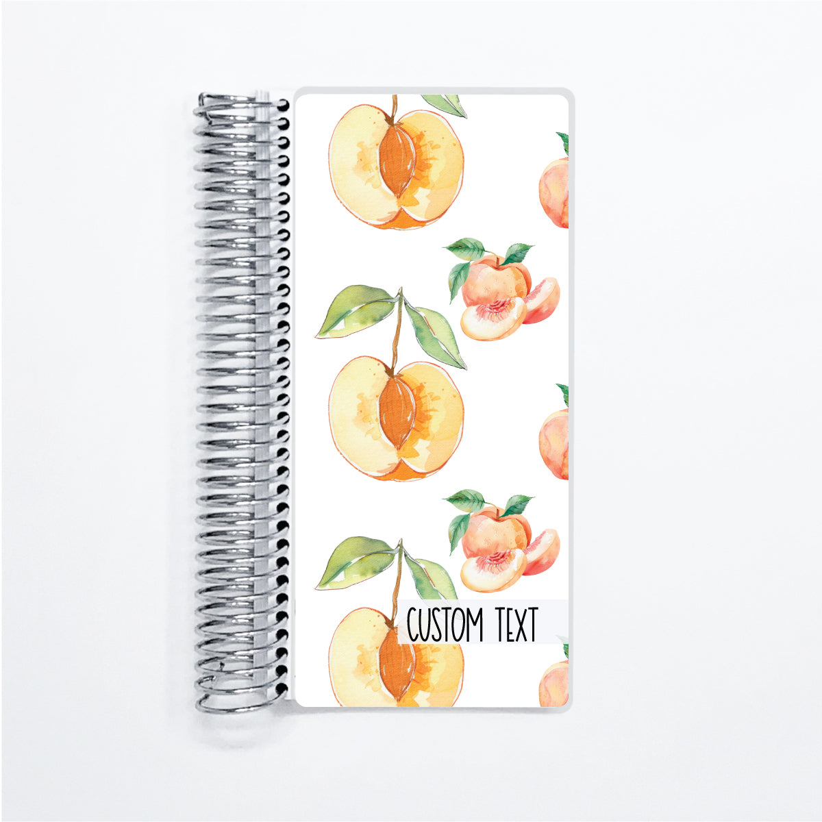 a spiral notebook with a pattern of peaches