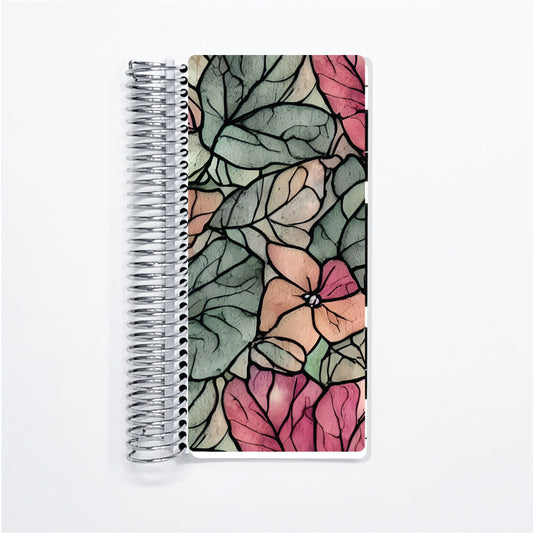 a spiral notebook with a floral design on it