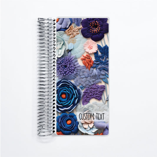 a spiral notebook with a floral design on it
